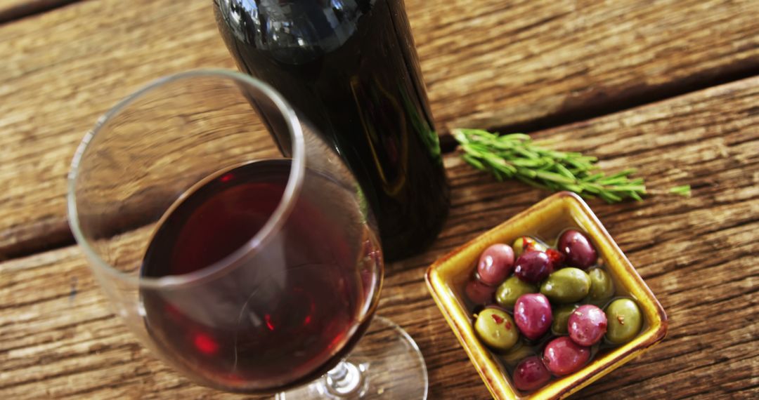 Glass of Red Wine with Olives on Rustic Wooden Table - Free Images, Stock Photos and Pictures on Pikwizard.com