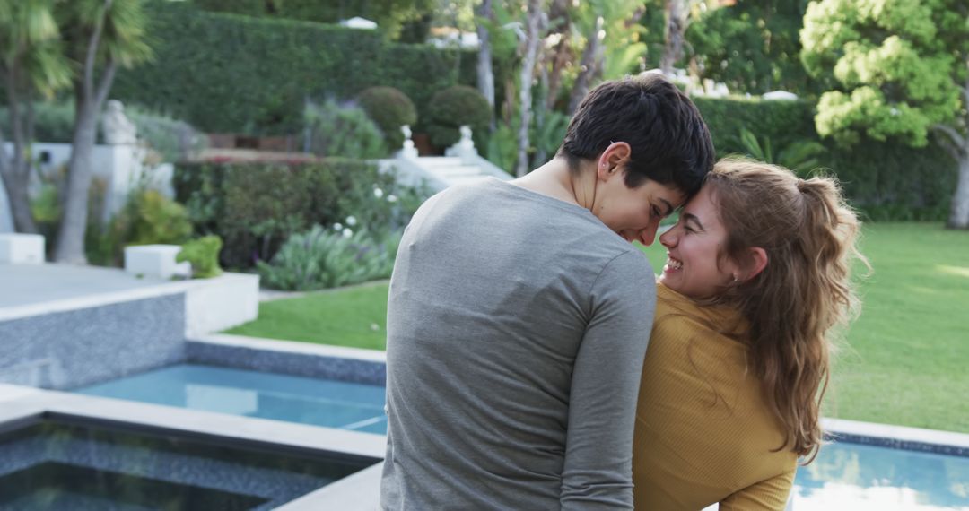 Couple Embracing by Pool in Lush Garden Background - Free Images, Stock Photos and Pictures on Pikwizard.com