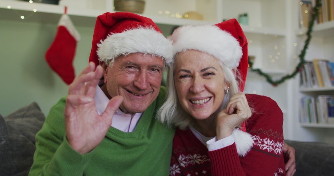 Happy Senior Couple Celebrating Christmas with Santa Hats - Free Images, Stock Photos and Pictures on Pikwizard.com