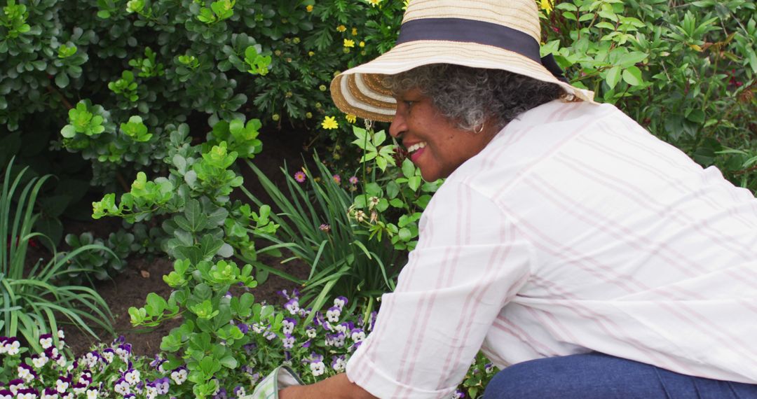 Senior Woman Gardening in Yard with Hat, Flowers, and Greenery - Free Images, Stock Photos and Pictures on Pikwizard.com