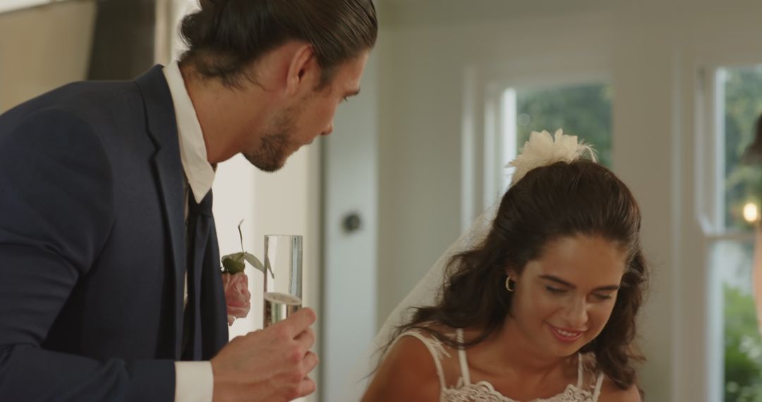 Smiling Couple Toasting with Champagne at Wedding Reception