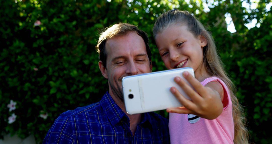 Father and Daughter Taking Selfie Together Outdoors - Free Images, Stock Photos and Pictures on Pikwizard.com