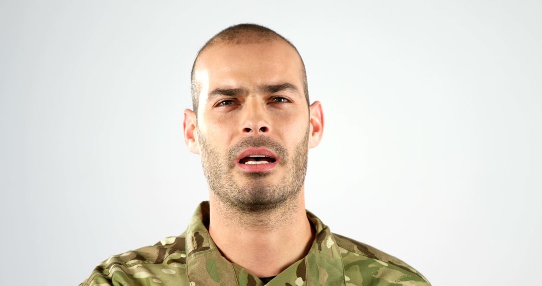 Focused Military Officer in Camouflage Uniform with Determined Expression