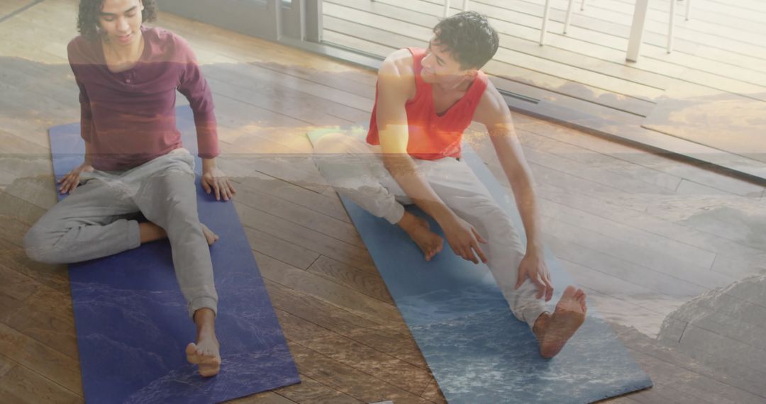 Yoga Partners Practicing Stretching in Natural Light Studio
