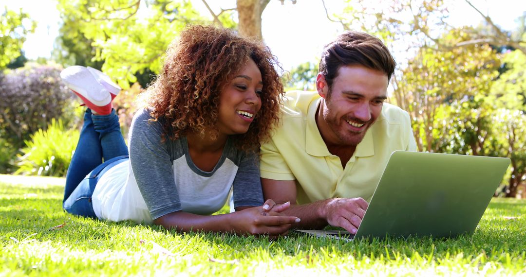 Happy Multi-Ethnic Couple Using Laptop Outside - Free Images, Stock Photos and Pictures on Pikwizard.com