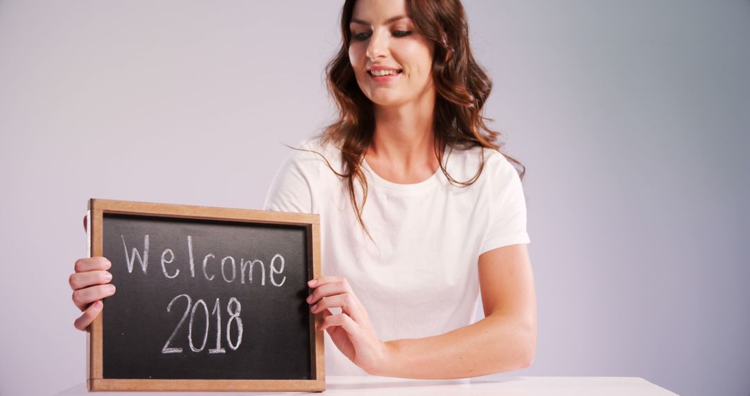 Woman Holding Chalkboard with Welcome 2018 Message - Free Images, Stock Photos and Pictures on Pikwizard.com