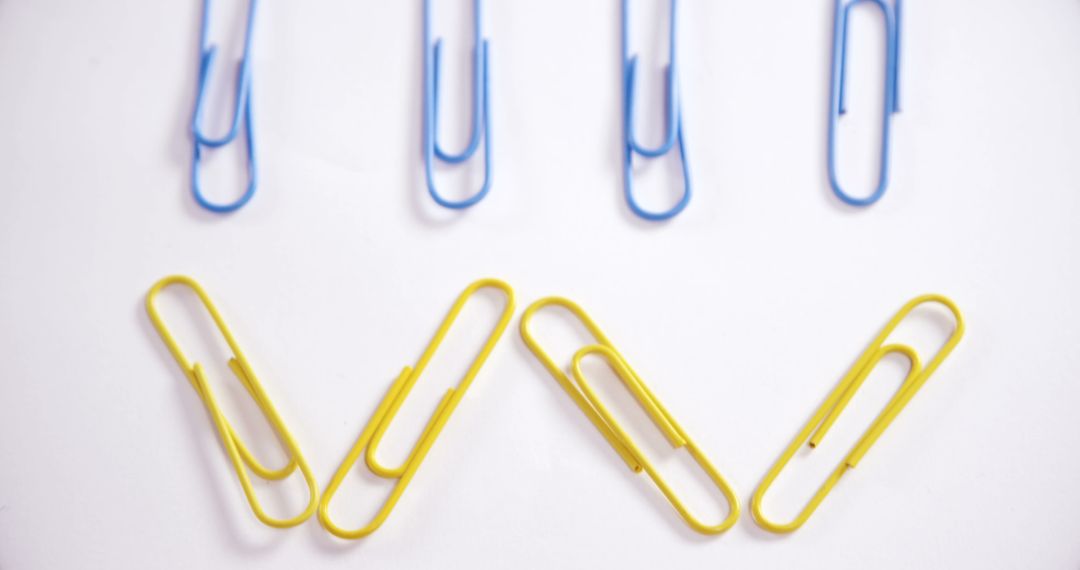 Blue and Yellow Paper Clips on White Background - Free Images, Stock Photos and Pictures on Pikwizard.com