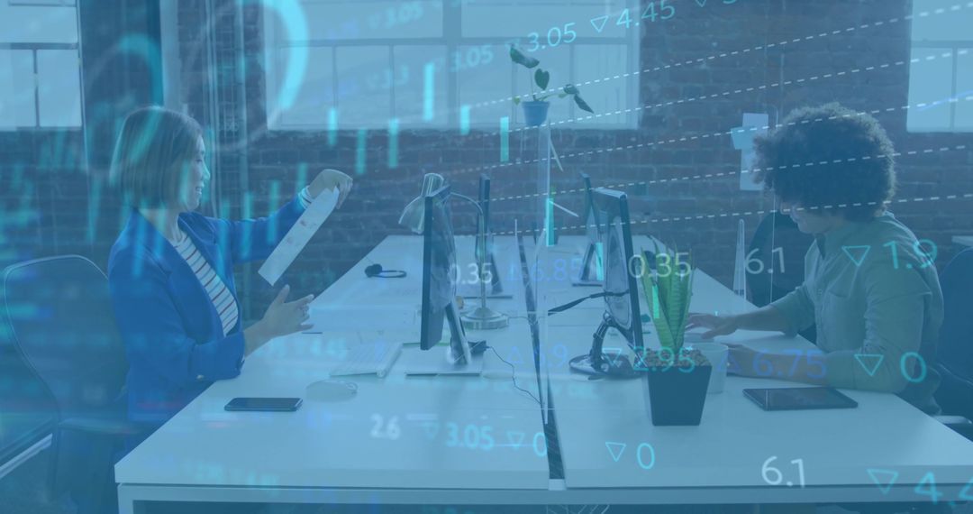 Collaborating at shared workspace, analyzing financial data overlay on desktop monitors