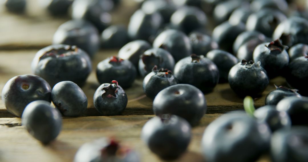 Fresh Blueberries Scattered on Wooden Table - Free Images, Stock Photos and Pictures on Pikwizard.com