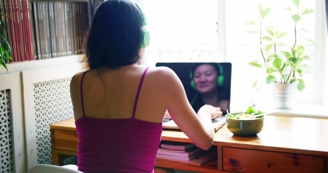 Woman Having Virtual Meeting at Home with Green Headphones - Free Images, Stock Photos and Pictures on Pikwizard.com