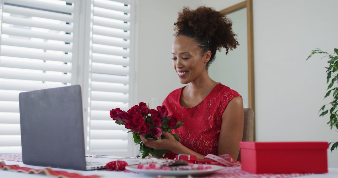 Woman Arranging Red Roses in Home Office for Valentine's Day - Free Images, Stock Photos and Pictures on Pikwizard.com
