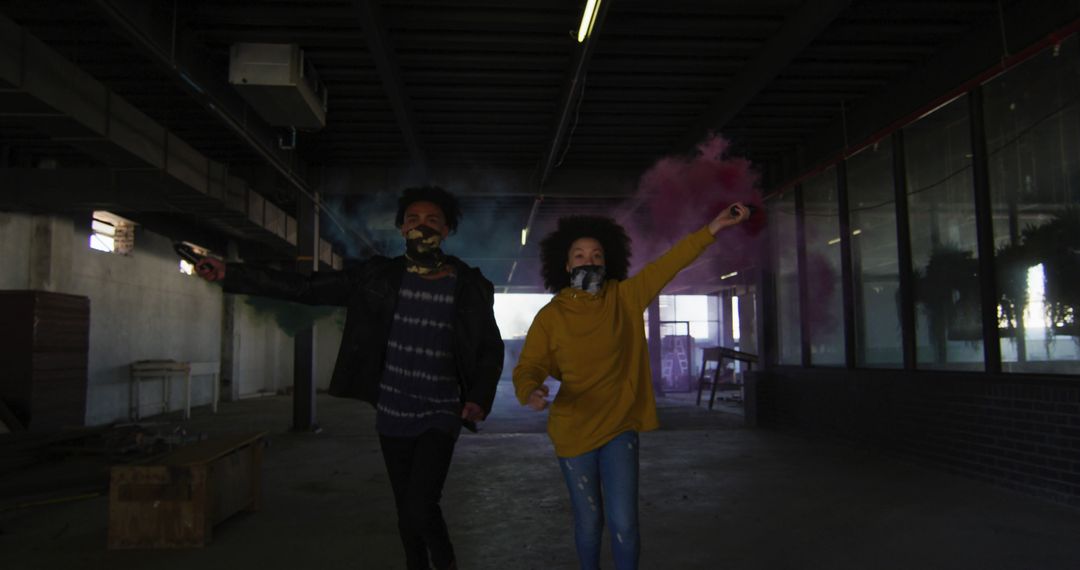 Young Couple Celebrating with Smoke Bombs in Grungy Urban Space - Free Images, Stock Photos and Pictures on Pikwizard.com