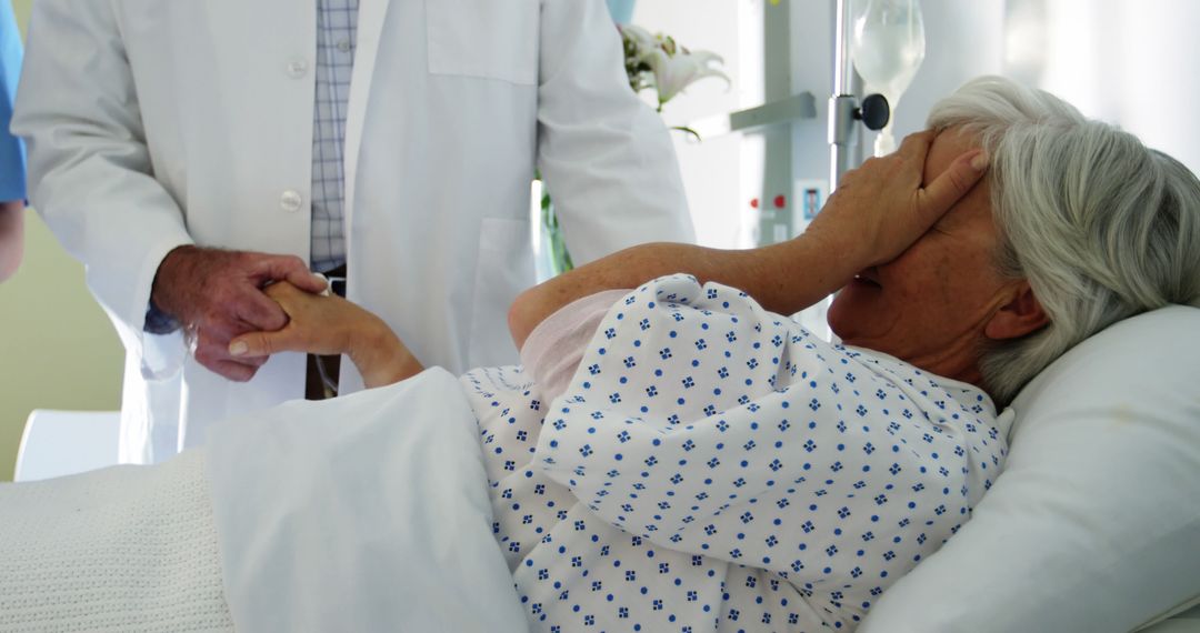 Doctor Comforting Senior Female Patient in Hospital Bed - Free Images, Stock Photos and Pictures on Pikwizard.com