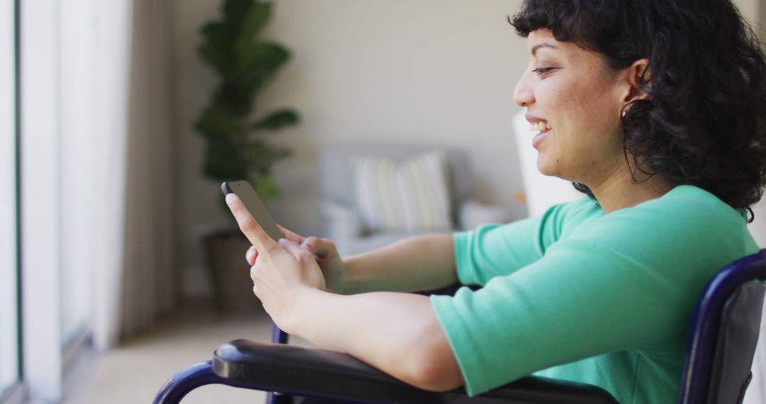 Smiling Woman in Wheelchair Using Smartphone at Home - Free Images, Stock Photos and Pictures on Pikwizard.com