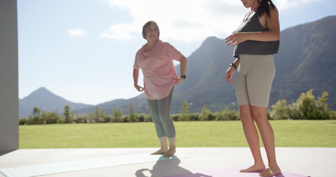 Women Exercising on Mats with Scenic Mountain Views