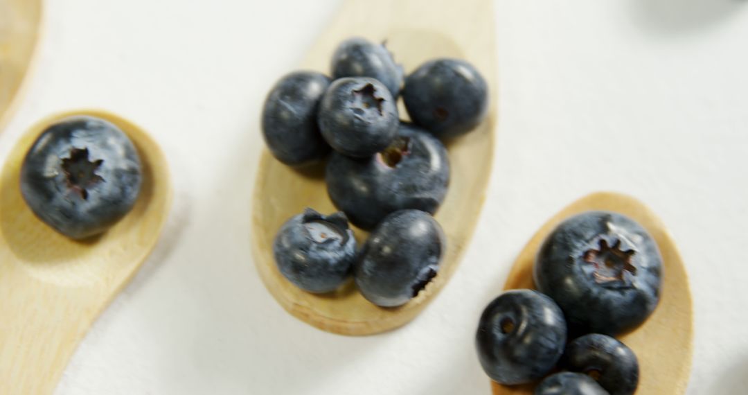 Fresh Blueberries on Wooden Spoons Against White Background - Free Images, Stock Photos and Pictures on Pikwizard.com