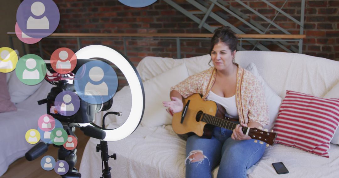 Female Vlogger Playing Guitar During Home Social Media Recording