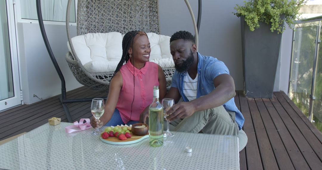Couple Enjoying Wine and Fruit on a Relaxing Patio