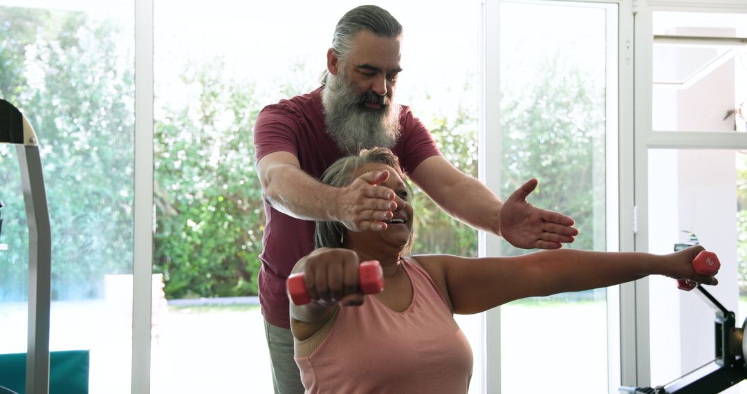 Senior Couple Exercising Together at Home with Hand Weights
