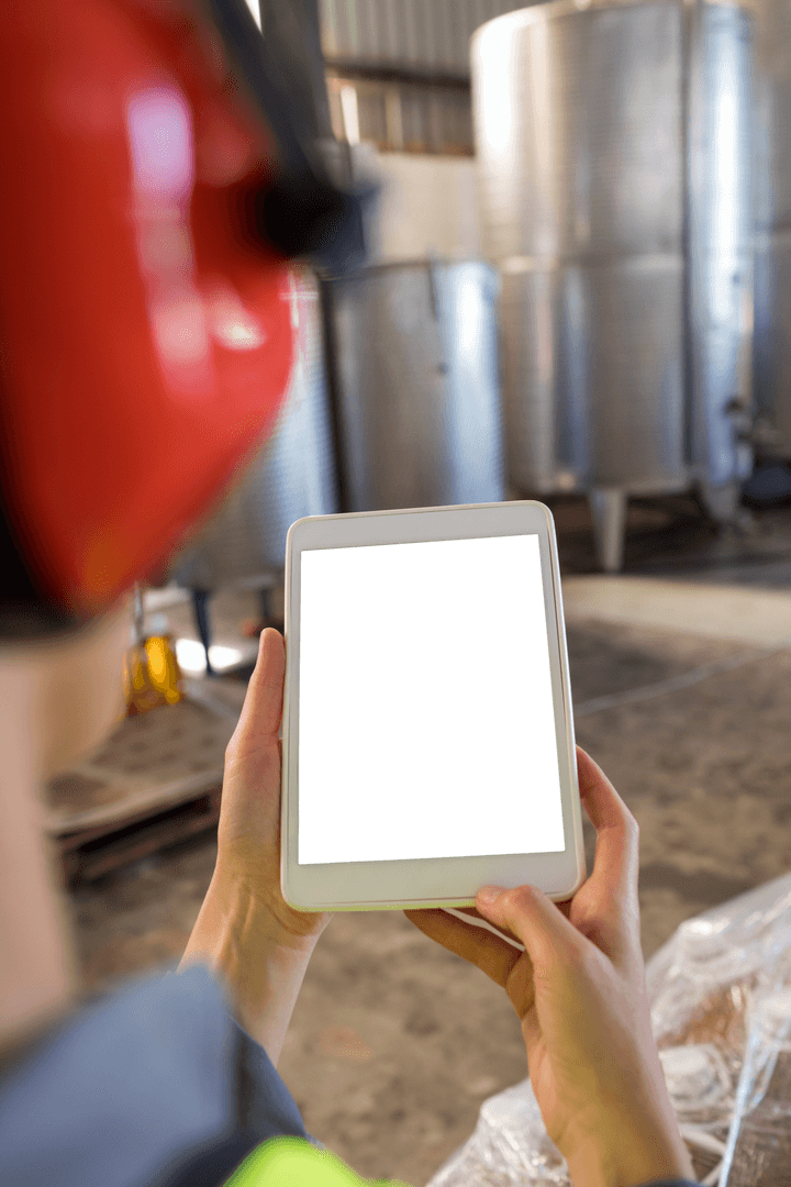 Technician Using Transparent Tablet in Industrial Facility