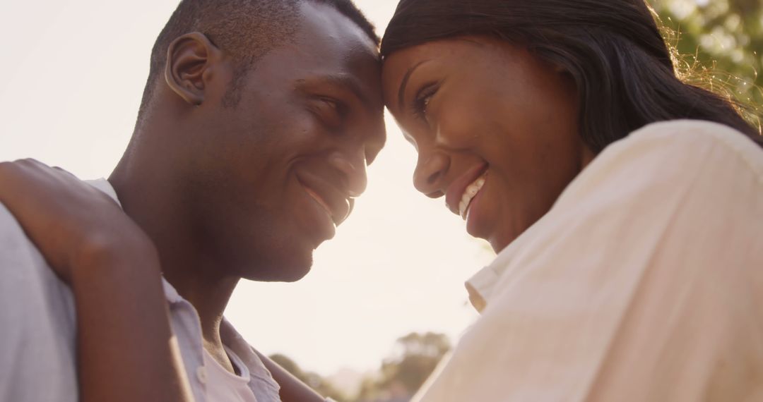 Romantic Couple Embracing Outdoors During Sunset - Free Images, Stock Photos and Pictures on Pikwizard.com