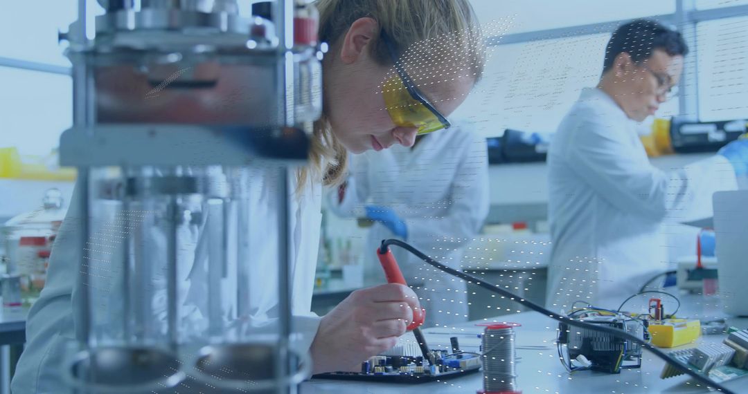Female Engineer Soldering Circuit Board in Electronics Lab
