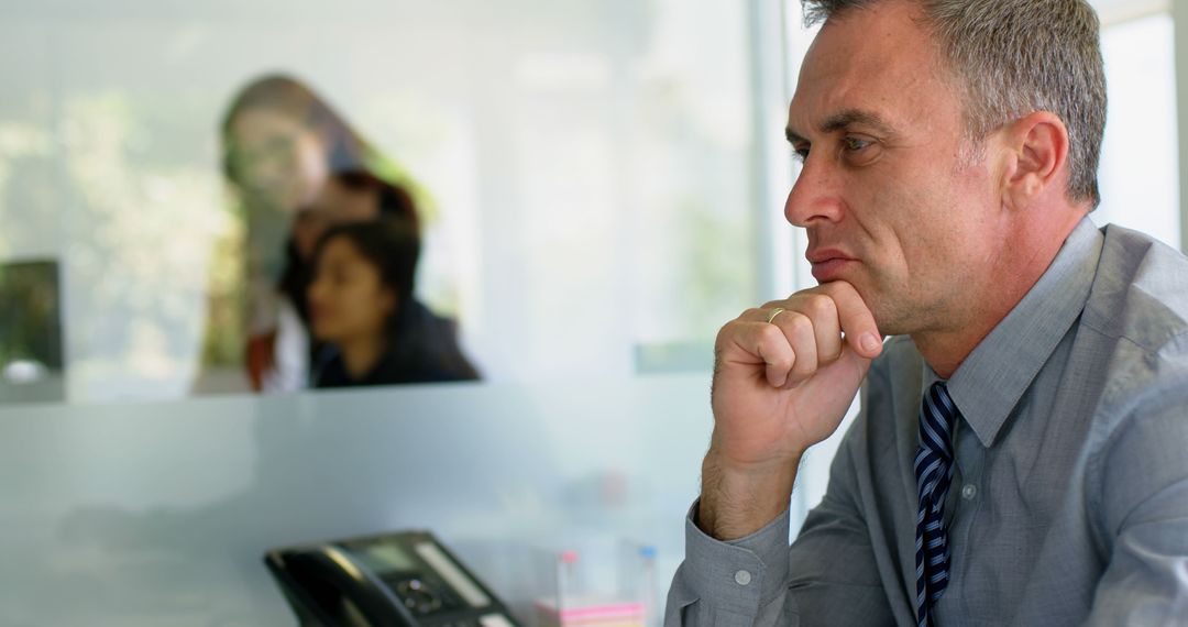 Caucasian Businessman Reflecting on Corporate Strategy in Office