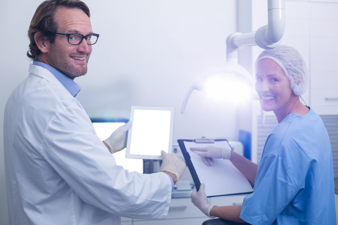 Happy Dentists Explaining Diagnosis with Transparent Tablet - Download Free Stock Images Pikwizard.com