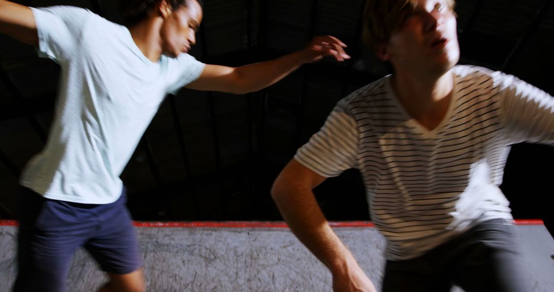 Two Young Men Skateboarding in a Halfpipe Under Bright Lights - Free Images, Stock Photos and Pictures on Pikwizard.com