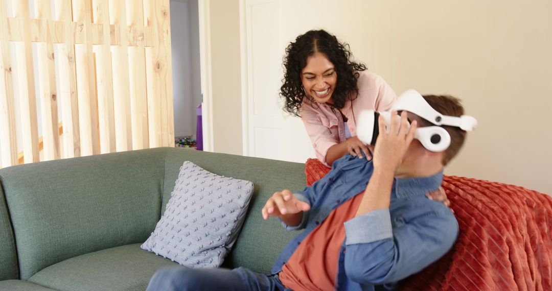 Joyful Couple Enjoying Virtual Reality Entertainment at Home