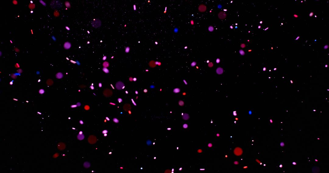 Colorful confetti dots float in a dark background, ideal for festive designs - Free Images, Stock Photos and Pictures on Pikwizard.com