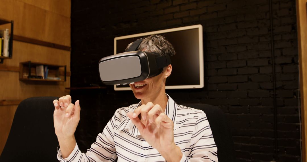 Woman Experiencing Virtual Reality with VR Headset in Modern Office - Free Images, Stock Photos and Pictures on Pikwizard.com