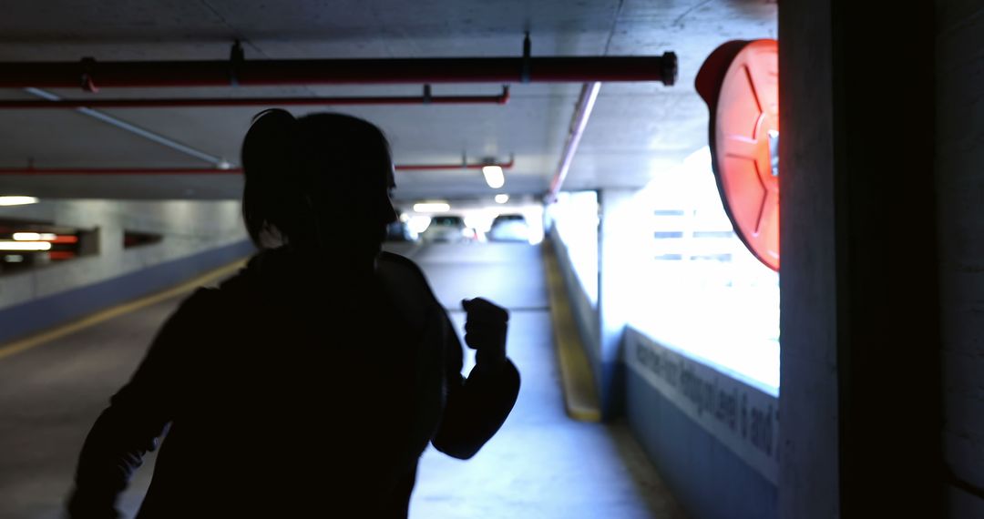 Silhouette of Woman Running in Parking Garage - Free Images, Stock Photos and Pictures on Pikwizard.com