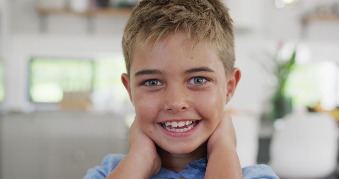 Smiling Young Boy Posing in Modern Kitchen - Free Images, Stock Photos and Pictures on Pikwizard.com