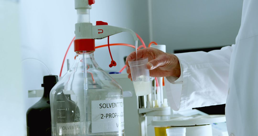 Scientist Conducting Laboratory Experiment with Chemical Solvent - Free Images, Stock Photos and Pictures on Pikwizard.com