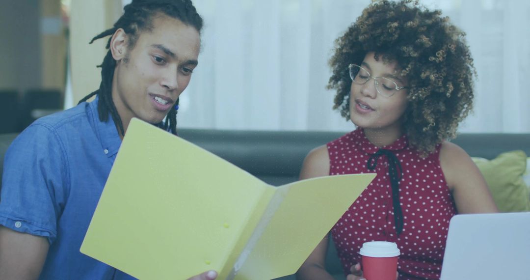 Colleagues Collaborating with Documents in Relaxed Office