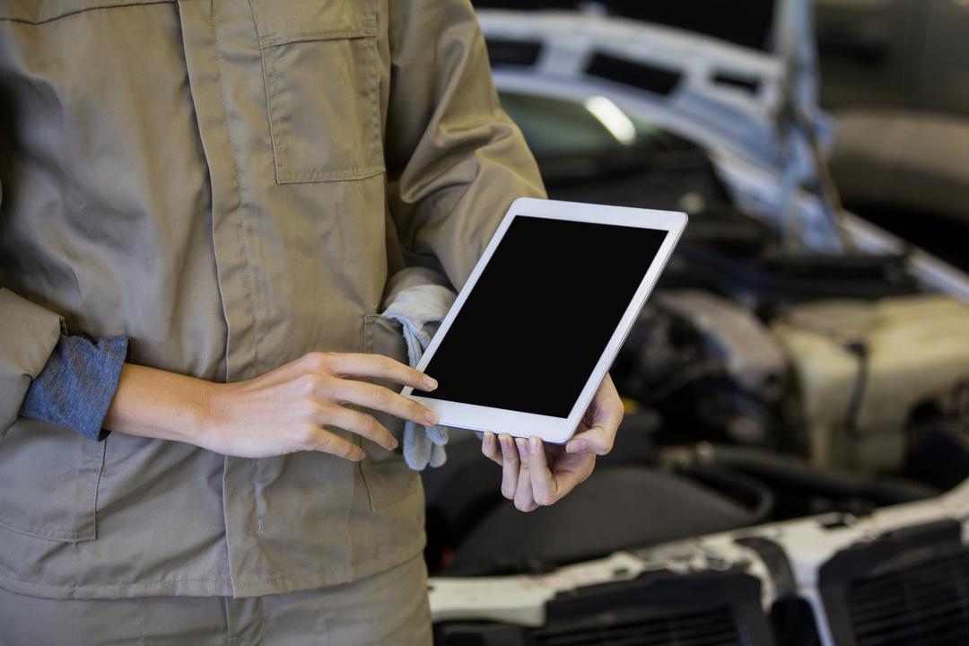 Mechanic Using Digital Tablet in Repair Garage - Free Images, Stock Photos and Pictures on Pikwizard.com