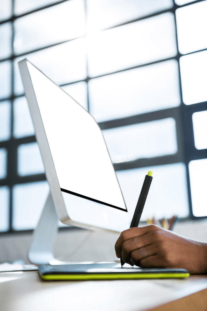 Graphic Designer Using Tablet in Transparent Modern Office