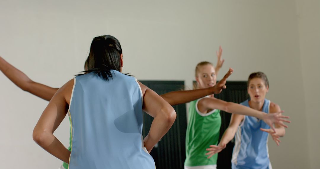 Female Basketball Players Practicing Defensive Drills in Gym