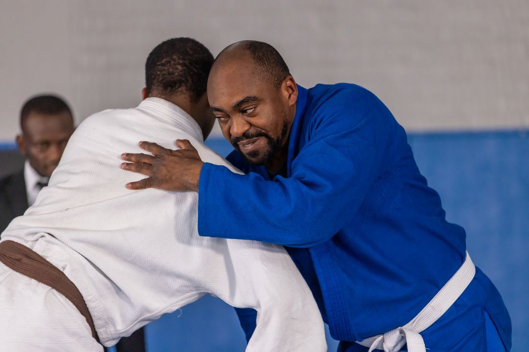 Diverse Male Judo Competitors Grappling in Intense Match