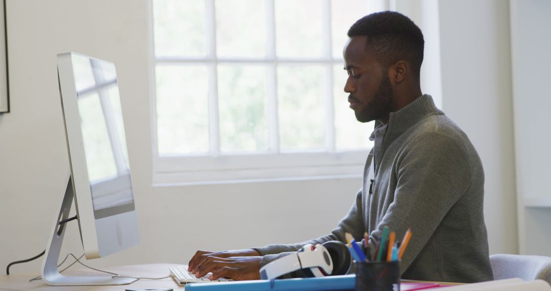 Focused Businessman Typing in Bright Office Space