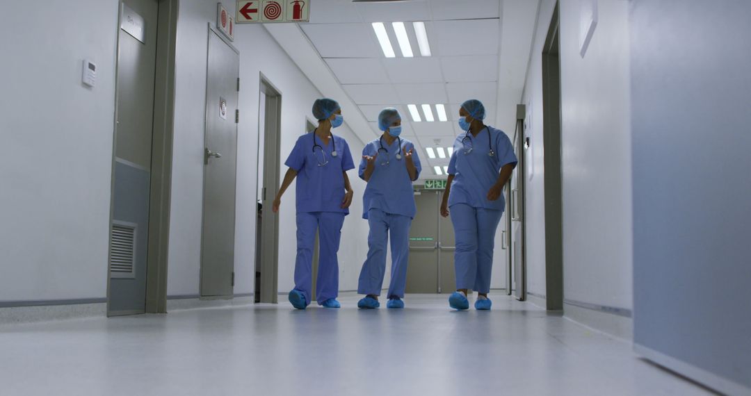 Team of Healthcare Workers Walking in Hospital Hallway - Free Images, Stock Photos and Pictures on Pikwizard.com