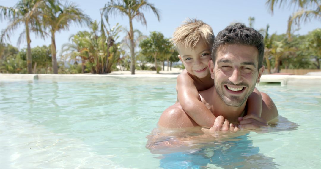 Father and Son Enjoying Pool Time on a Sunny Day - Free Images, Stock Photos and Pictures on Pikwizard.com