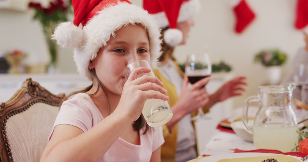 Children Enjoying Holiday Meal Wearing Santa Hats - Free Images, Stock Photos and Pictures on Pikwizard.com