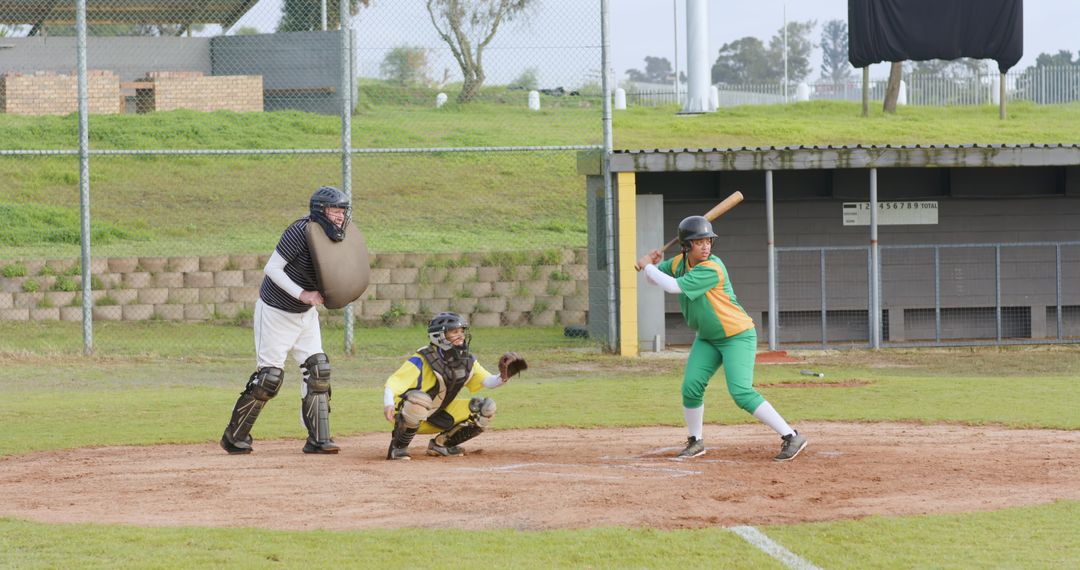 Softball Players Embracing Competition and Skills Outdoors on Field