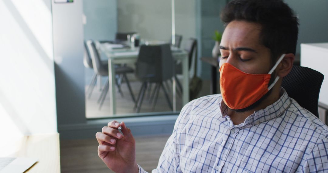 Businessman Meditating in Office with Face Mask - Free Images, Stock Photos and Pictures on Pikwizard.com