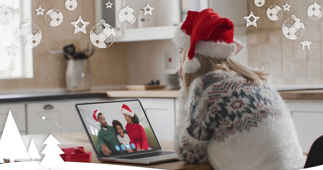 Woman in Christmas Sweater Video Calling Family on Laptop in Festive Kitchen - Free Images, Stock Photos and Pictures on Pikwizard.com