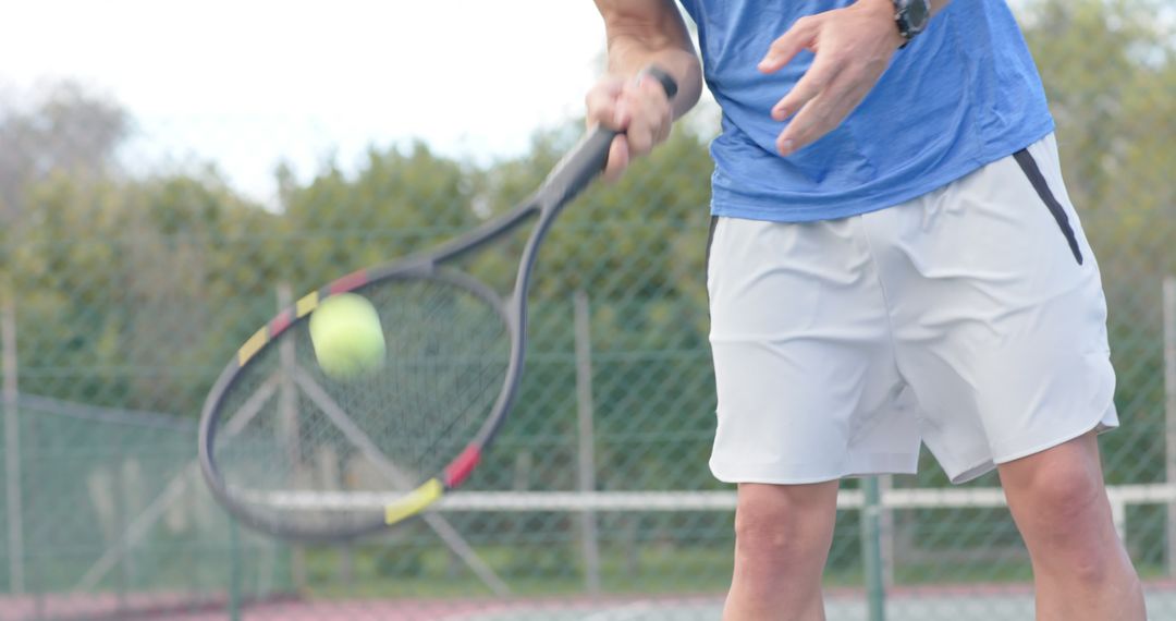 Man Playing Tennis Focused on Hitting Ball - Free Images, Stock Photos and Pictures on Pikwizard.com