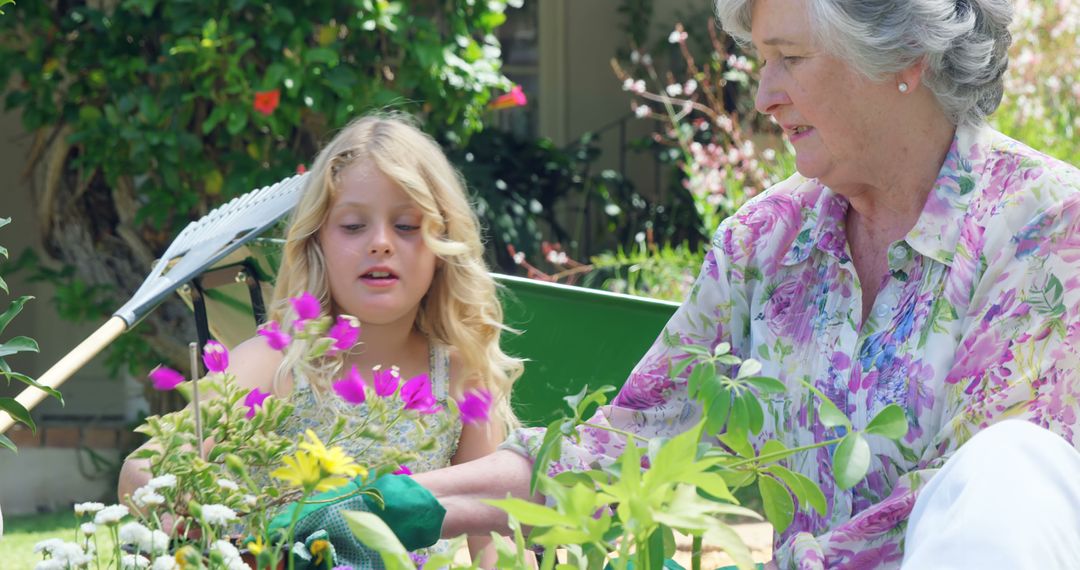 Grandmother Bonding with Granddaughter in Vibrant Garden - Free Images, Stock Photos and Pictures on Pikwizard.com