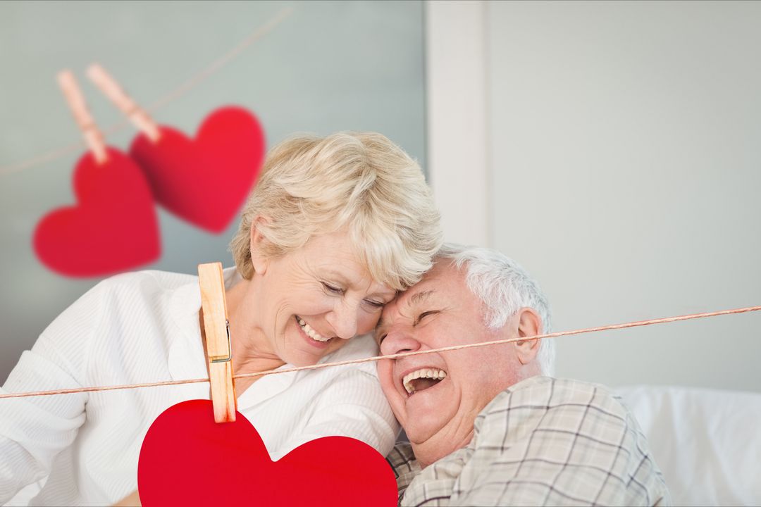 Smiling Elderly Couple Celebrating Love with Hearts Decoration - Download Free Stock Templates Pikwizard.com